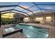 Screened pool with spa and outdoor lounge and dining, enhancing outdoor living and entertaining at 11550 Blackfin St, Venice, FL 34292