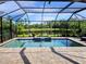 Screened-in pool featuring a connected spa, brick patio, and a serene lake view at 11550 Blackfin St, Venice, FL 34292