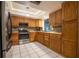Well-appointed kitchen featuring wooden cabinetry, stainless steel appliances, and a classic tile backsplash at 1208 Francis Ave, Sarasota, FL 34232
