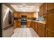 Well-appointed kitchen featuring wooden cabinetry, stainless steel appliances, and a classic tile backsplash at 1208 Francis Ave, Sarasota, FL 34232