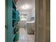 Functional laundry room with tile flooring, window, shelving and washer and dryer at 1208 Francis Ave, Sarasota, FL 34232