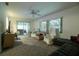 Comfortable living room with plush carpeting, large windows, and sliding door access to the outdoors at 1208 Francis Ave, Sarasota, FL 34232
