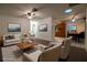 Bright living room featuring neutral furniture, ceiling fan, and seamless flow to the adjacent dining area and kitchen at 1208 Francis Ave, Sarasota, FL 34232