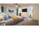 Serene main bedroom with a ceiling fan, ensuite bathroom, and natural light creating a relaxing retreat at 1208 Francis Ave, Sarasota, FL 34232