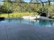 Inviting screened-in pool and hot tub area surrounded by lush greenery, perfect for relaxation at 12342 Lavender Loop, Bradenton, FL 34212