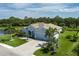 Aerial of house featuring manicured lawn, mature landscaping, and a lake in a serene residential neighborhood at 15808 42Nd E Gln, Parrish, FL 34219