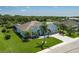 Aerial of house with screened-in pool and well-manicured lawn in tranquil neighborhood near a scenic pond at 15808 42Nd E Gln, Parrish, FL 34219
