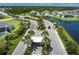 Aerial view of the gated community entrance, manicured landscaping, and pond at 15808 42Nd E Gln, Parrish, FL 34219