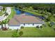 Spacious backyard with well-maintained lawn, mature landscaping, and view of the community pond at 15808 42Nd E Gln, Parrish, FL 34219