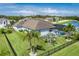Aerial view of backyard with a screened pool, beautiful landscaping, and community pond at 15808 42Nd E Gln, Parrish, FL 34219