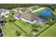 Beautiful backyard aerial view with a screened pool, lush green lawn, and black metal fence at 15808 42Nd E Gln, Parrish, FL 34219