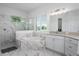 Luxurious bathroom showcasing a soaking tub, glass-enclosed shower, and marble-tiled walls at 15808 42Nd E Gln, Parrish, FL 34219