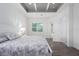 Light-filled bedroom featuring a decorative ceiling, wood floors, and outdoor access at 15808 42Nd E Gln, Parrish, FL 34219