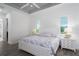Bright bedroom featuring a decorative tray ceiling, wood floors, and sunlit windows at 15808 42Nd E Gln, Parrish, FL 34219