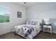 Charming bedroom with a decorative bed, side table, and view from the window at 15808 42Nd E Gln, Parrish, FL 34219