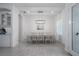 Bright dining room featuring an 8-chair table, modern light fixture, and large window at 15808 42Nd E Gln, Parrish, FL 34219