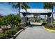 Community entrance with stone pillars, lush landscaping, and a welcoming gate at 15808 42Nd E Gln, Parrish, FL 34219