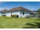 Exterior view showcasing the house's architecture with a backyard featuring a cozy deck and a screened-in pool at 15808 42Nd E Gln, Parrish, FL 34219
