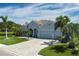 Charming home with meticulous landscaping, a paver driveway, and a three-car garage situated on a lush lot at 15808 42Nd E Gln, Parrish, FL 34219