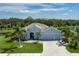Desirable home on an oversized lot, with a paver driveway and three-car garage, surrounded by mature palms and greenery at 15808 42Nd E Gln, Parrish, FL 34219