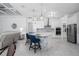 Open kitchen featuring an island with seating, stainless steel appliances, and modern pendant lighting at 15808 42Nd E Gln, Parrish, FL 34219