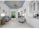 Bright living room with neutral décor, tile floors, tray ceiling, and views of outdoor pool area at 15808 42Nd E Gln, Parrish, FL 34219