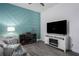 Open-concept living room featuring a TV, accent wall and modern decor at 15808 42Nd E Gln, Parrish, FL 34219