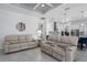 Bright living room showcasing neutral furniture, stylish flooring, and an open floor plan to the kitchen at 15808 42Nd E Gln, Parrish, FL 34219