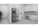 Pantry featuring a stainless steel refrigerator, desk area, and tile backsplash at 15808 42Nd E Gln, Parrish, FL 34219