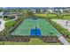 Community basketball court with green surface and blue key, surrounded by manicured landscaping at 16415 Star Grass Cir, Bradenton, FL 34211