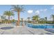 Community pool featuring lounge chairs, umbrellas, lush landscaping, and a clear blue swimming pool at 16415 Star Grass Cir, Bradenton, FL 34211