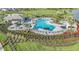 Aerial view of the community pool with lounge chairs, umbrellas, a gazebo, and lush landscaping at 16415 Star Grass Cir, Bradenton, FL 34211
