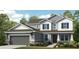 Charming two-story home featuring a gray garage door and a beautifully landscaped front yard at 16415 Star Grass Cir, Bradenton, FL 34211