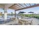 Poolside seating area featuring tables, chairs, shade, and a view of the pool and surrounding landscaping at 16415 Star Grass Cir, Bradenton, FL 34211