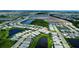 An aerial view showcases a community with ponds and homes, creating a serene environment at 18068 Cherished Loop, Bradenton, FL 34211