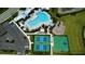 Aerial view featuring a community pool, playground, tennis courts, and parking area at 18068 Cherished Loop, Bradenton, FL 34211