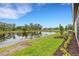 The home has a backyard with a pond view and manicured landscaping and lawn at 18068 Cherished Loop, Bradenton, FL 34211