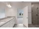 Bathroom with granite double vanity and glass door shower, providing a luxurious and modern feel at 18068 Cherished Loop, Bradenton, FL 34211