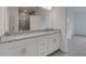Well-lit bathroom showcasing granite countertop vanities and a doorway leading to the bedroom at 18068 Cherished Loop, Bradenton, FL 34211