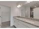 Elegant bathroom featuring double granite vanities and bright lighting, creating a spa-like experience at 18068 Cherished Loop, Bradenton, FL 34211