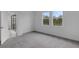 Bedroom with carpet and windows providing scenic nature views at 18068 Cherished Loop, Bradenton, FL 34211