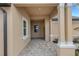 Covered entryway of the home features brick pavers, columns, and a view of the front door at 18068 Cherished Loop, Bradenton, FL 34211