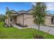 Charming home featuring a two-car garage, lush lawn, and stone-paved driveway at 18068 Cherished Loop, Bradenton, FL 34211