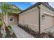 Inviting single-Gathering home featuring a two-car garage, landscaped walkway, and manicured garden at 18068 Cherished Loop, Bradenton, FL 34211