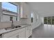 Bright kitchen with white cabinets, granite countertops, and stainless steel appliances overlooking backyard at 18068 Cherished Loop, Bradenton, FL 34211