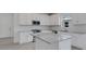 Stylish kitchen boasts white cabinetry, stainless steel appliances, and granite countertops at 18068 Cherished Loop, Bradenton, FL 34211