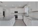 Modern kitchen with white cabinets, stainless steel appliances, and granite countertops at 18068 Cherished Loop, Bradenton, FL 34211
