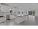 Bright, open kitchen featuring white cabinets, stainless steel appliances, and a granite island at 18068 Cherished Loop, Bradenton, FL 34211
