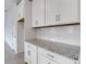 Modern kitchen features white cabinets, subway tile backsplash, and granite countertops at 18068 Cherished Loop, Bradenton, FL 34211
