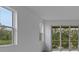 Bright living room with multiple windows and sliding door leading to outdoor scenery at 18068 Cherished Loop, Bradenton, FL 34211